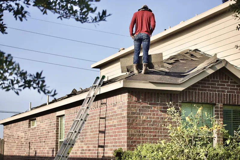 Professional roofer working on a residential roof in Palmyra